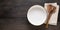 An empty large salad bowl with utensils on a linen napkin