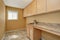 Empty laundry room with cabinets with granite counter top and sink