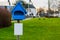 Empty leaflet box in the shape of a house, blank white sign with copy space, advertisement concept