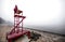 Empty lifeguard chair on the beach on a foggy morning.