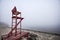 Empty lifeguard chair on the beach on a foggy morning.