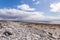 Empty limestone rocky beach of the island of Inis Oirr with the Atlantic Ocean and the Plassey shipwreck in the background