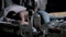 Empty liquor bottles on table with man sleeping in background