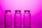 Empty little bottles on nice pink background