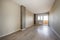 Empty living room with access to a terrace with brick walls