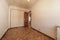 Empty living room with aluminum radiator, herringbone oak parquet