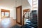 Empty living room with black marble staircase, apartment interior