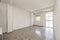 Empty living room with black polished old terrazzo floors with aluminum windows and bay window