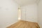 Empty living room with chestnut hardwood floorboards