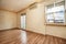 Empty living room with chestnut wood floors and freshly painted