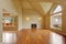 Empty living room with high ceiling and big arch window