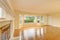 Empty living room interior with polished hardwood floor.