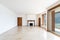 Empty living room with large windows overlooking the lake