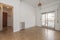 Empty living room with metal radiator, oak parquet floors