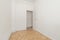 Empty living room with oak parquet and white wood carpentry and plain