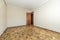 Empty living room with ugly brown sunscreen floor, dark wood door