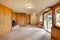 Empty living room with wood panel walls and cast iron fireplace