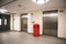 Empty lobby hallway with litter bin and closed lift elevator doors