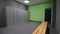 Empty locker room with wooden bench and row of grey cabinets