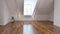 Empty loft room interior with dormer window