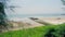 Empty Long Hai Beach with waving tree branches from wind Vung Tau Province, Vietnam