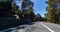 Empty long mountain road to the horizon on a sunny summer day at bright sunset