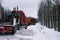 Empty long vehicles on winter road among forest