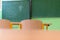 Empty Mathematics classroom with school desks, chairs and blackboard.