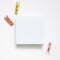 Empty memo paper, sticky notes and wooden clothespins on white background