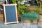 Empty menu advertising board and wooden box of grass