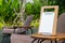 Empty menu frame standing on wood table in outdoor cafe near the