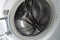 Empty metal drum washing machine close up