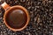 Empty Mexican clay mug and dark roasted coffee beans