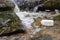 Empty Milk Jug litter floating in Pristine Flowing Stream showing environmental pollution