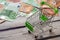 Empty mini shopping cart and euro banknote on wooden table. Business, finance and online shopping