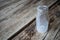 Empty miniature milk bottle on a dark wood rustic table