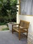 Empty minimal style cozy wooden bench with arms decorated on a white wall.