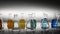 Empty and mixed color liquid filled erlenmeyer flasks reflecting on table