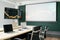 Empty modern meeting room in the office with laptops and digital tablet on the table, monitor and projector screen.