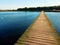 Empty mole on blue lake, wharf for hired boats in marina. Ready for trip ships.