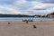 Empty morning beach in Croatia with paddle boards ready standing on the edge of the beach with the sea and mountains in the