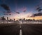 Empty motorway heading for the modern city with skyscrapers silhouettes