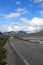 Empty mountain road landscape Norway mountains summer blue sky clouds travel highway rural country nature asphalt green beautiful