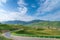 Empty mountain road winding on alpine meadows