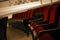 Empty movie theater auditorium with fancy red chairs