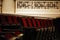 Empty movie theater auditorium with fancy red chairs