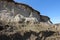 Empty nests, burrows of birds in the sand cliffs. Numerous holes of nests of swallows or swifts in the sandy slope