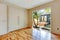 Empty nice room with hardwood floor and large doors.