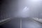 Empty night road with dense fog. Dangerous driving conditions.