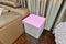 Empty nightstand in bedroom with pink fabric covered, interior d